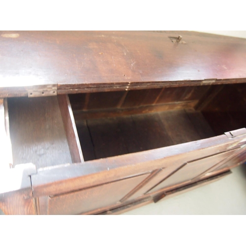 91 - An antique oak wooden mule chest with hinged top opening to reveal storage space and candle box