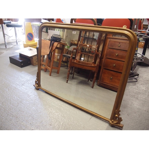 97 - An antique giltwood framed oval mantle mirror with hand carved scroll leaf design detailing
