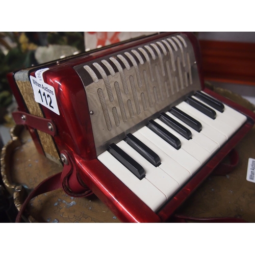 112 - A vintage Hohner Mignon-1 miniature 8 bass accordion with a music book