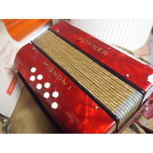 112 - A vintage Hohner Mignon-1 miniature 8 bass accordion with a music book