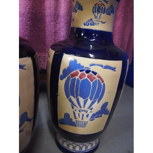 32 - A pair of decorative ceramic vases with an air balloon design, approx. height 53cm