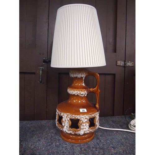 35 - A retro German glazed lava lamp with cut out detail to base, includes shade, overall height with sha... 