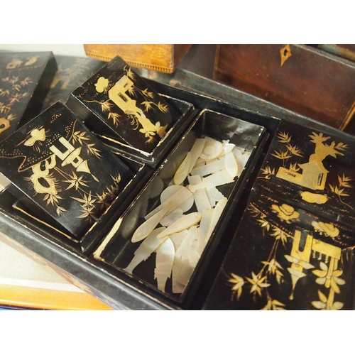 51 - Antique black and gold lacquered box with hand painted Japanese scenes, the box contains five co-ord... 