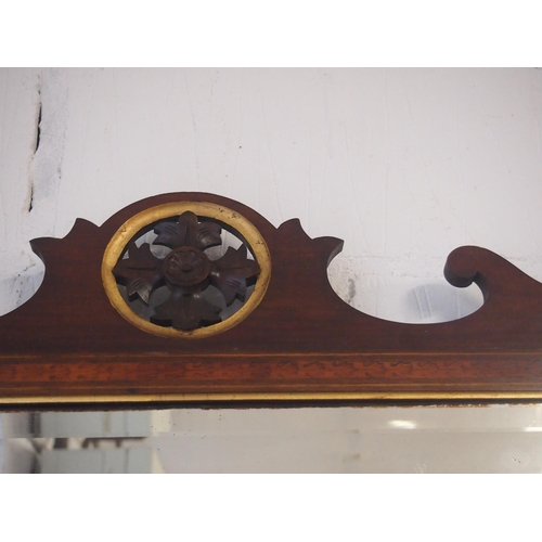 61 - An antique Georgian mahogany wall mirror. The bevelled rectangular glass sits in a moulded frame inl... 