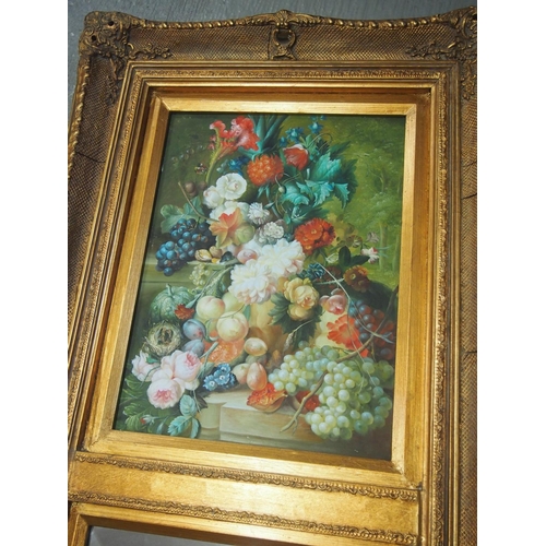 72 - A vintage ornately decorated bevelled mirror in gilt frame with hand painted still life scene of fru... 