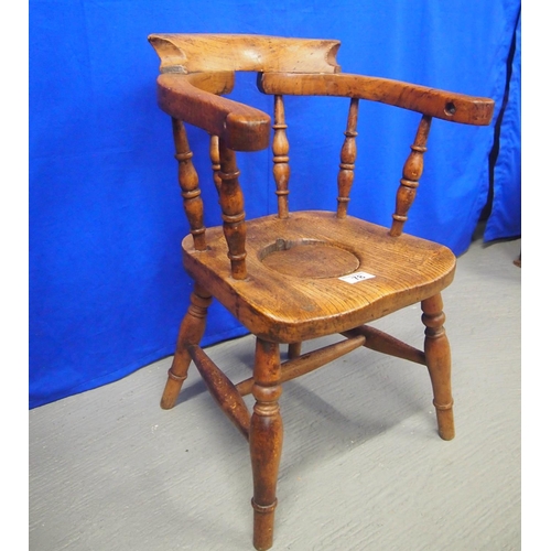 78 - Antique child's spindle back elbow chair with commode seat on turned supports and stretchers