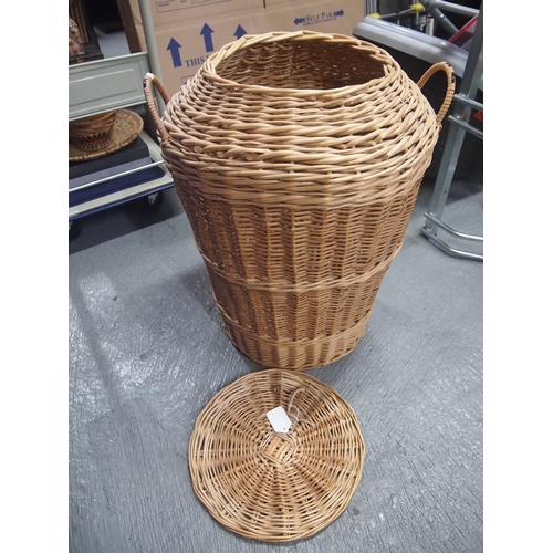 84 - A twin handled Ali-baba style wicker laundry/storage basket with lid