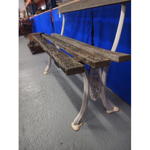 89 - A vintage slated wooden garden bench with cast iron supports, approx. size L127cm, D40cm, H47cm