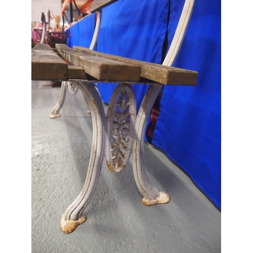 90 - A vintage slated wooden garden bench with cast iron supports, approx. size L127cm, D40cm, H47cm