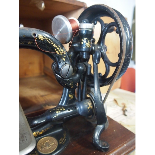 5 - Antique Willcox & Gibbs tabletop sewing machine with wooden case, original booklet and key