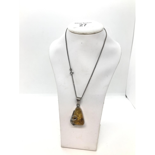 27 - An art nouveau style silver and amber pendant with silver chain, both stamped 925, approx. length of... 