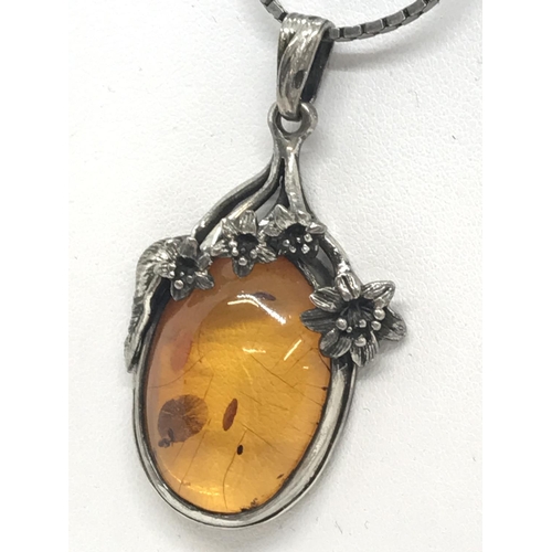 28 - A silver and amber pendant with flower design and silver box chain, both stamped 925, approx. length... 