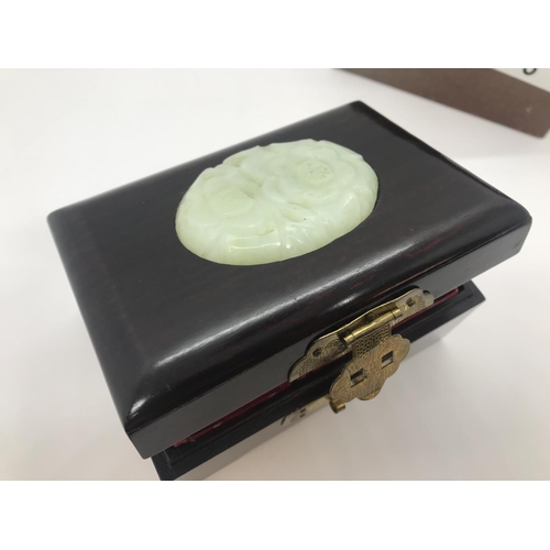 3 - An oriental wooden jewellery box with brass coloured clasps and carved jadeite /soapstone with carve... 