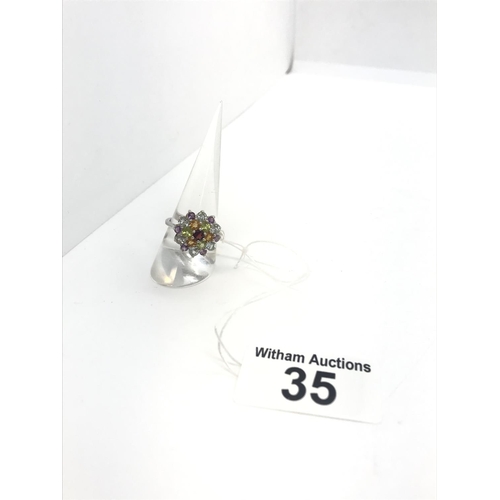 35 - A silver multi colour crystal ring stamped 925, approx. size O/P