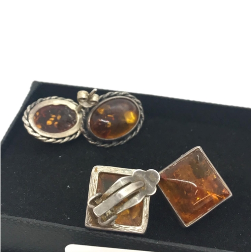 37 - A pair of silver and amber cabochon rope design earrings, stamped AD 925 together with a pair of sil... 