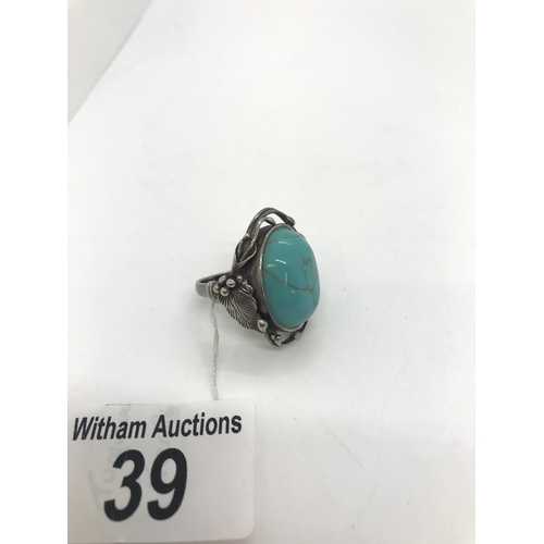 39 - A turquoise and silver ring with art nouveau style mount, stamped 925, approx. size O