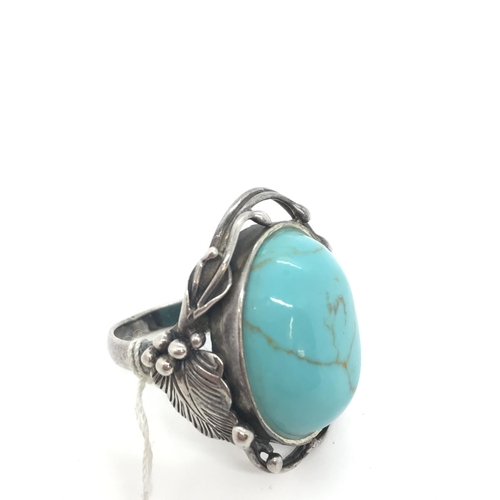 39 - A turquoise and silver ring with art nouveau style mount, stamped 925, approx. size O