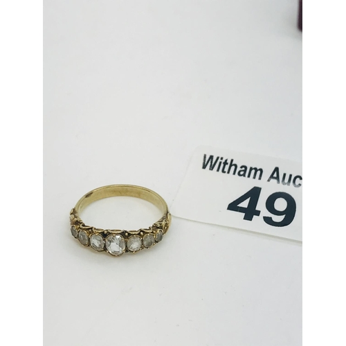 49 - A vintage 9ct yellow gold ring with seven graduated stones set into scroll mount, unmarked tested 9c... 