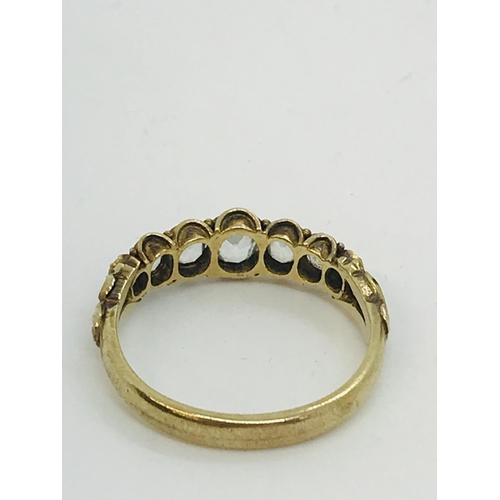 49 - A vintage 9ct yellow gold ring with seven graduated stones set into scroll mount, unmarked tested 9c... 