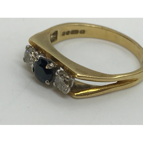 131 - An 18ct yellow gold diamond and sapphire ring in a rectangular bar design, the larger central sapphi... 