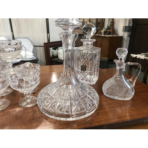 138 - A quantity of cut glass/crystal decanters in various designs and all with stoppers, together with a ... 