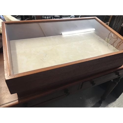 83 - An oak and glass display case with brass handle to side for top opening complete with padlock and ke... 