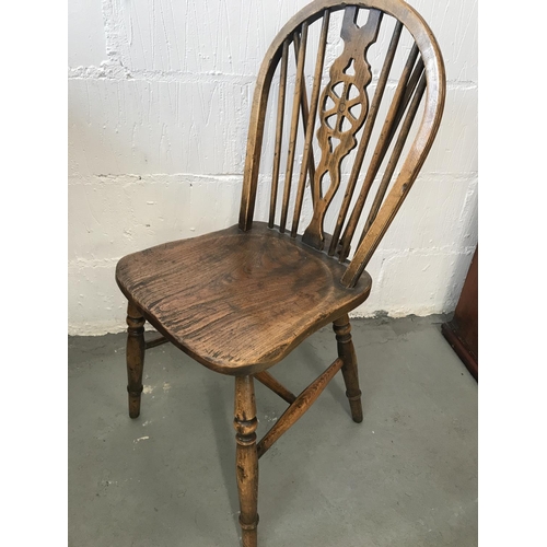 90 - A solid oak drop leaf gate leg table and x4 Windsor style wheelback chairs (of which 2 are carvers),... 