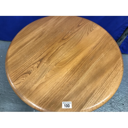 100 - An Ercol circular Coffee table with a glass under shelf, model LT 1061