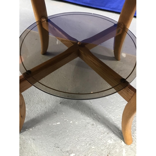 100 - An Ercol circular Coffee table with a glass under shelf, model LT 1061