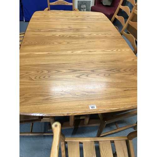 101 - An Ercol 8-seater (extendable) Penn / Windsor dining table with eight Ercol ladderback chairs, two o... 