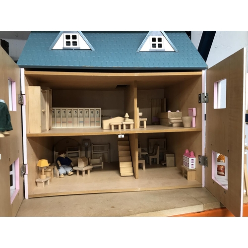 24 - A Doll's House with hinged open front doors together with a large quantity of wooden furniture, appr... 