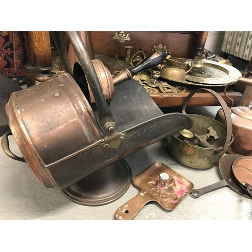 57 - A large quantity of brass and copper items including coal scuttle with handle and shovel, jug, pans ... 