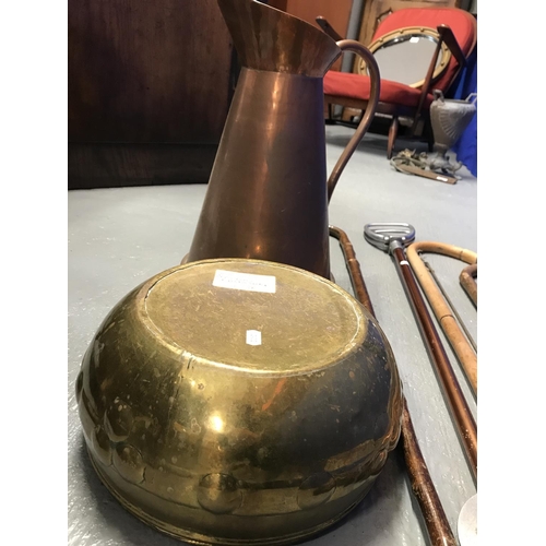 61 - Arts & Craft brass coloured bowl together with a large copper jug containing a selection of walking ... 