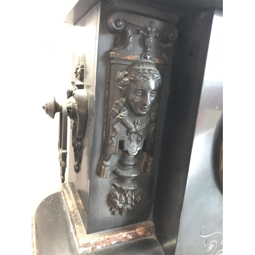 62 - A large Victorian black slate and marble mantle clock with cherub and Grecian design to facades, com... 