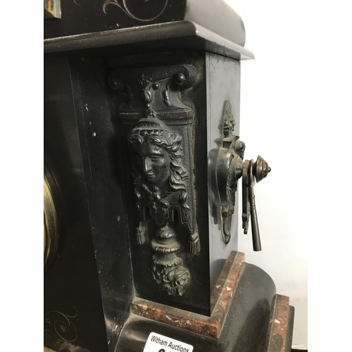 62 - A large Victorian black slate and marble mantle clock with cherub and Grecian design to facades, com... 