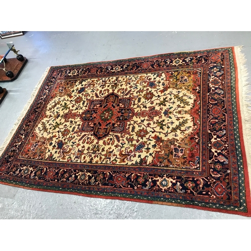 82 - A large rectangular rug with cotton fringe trim of Persian design, approx. size L290cm x W 205cm