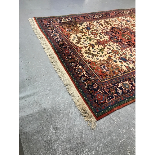 82 - A large rectangular rug with cotton fringe trim of Persian design, approx. size L290cm x W 205cm