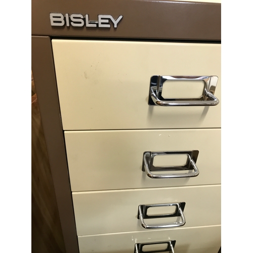 67 - A Bisley 9 drawer filing cabinet on platform with castors, approx. H100cm, together with a matching ... 