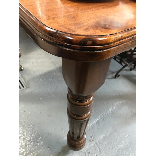 76a - Antique mahogany extendable table with decorate turned legs on castors, with winder