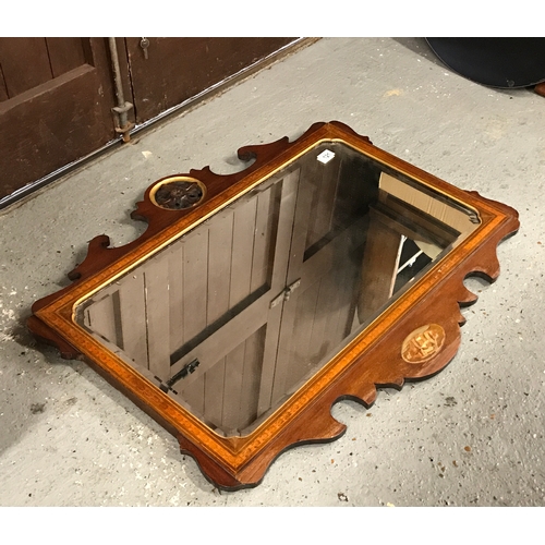 121 - An antique Georgian mahogany wall mirror. The bevelled rectangular glass sits in a moulded frame inl... 