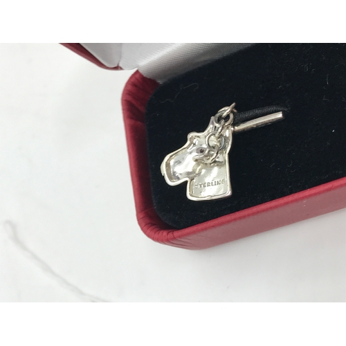 200 - A pair of 'textured' silver dog head cufflinks stamped Sterling