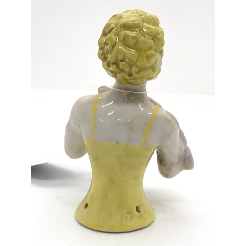 206 - A ceramic pin doll