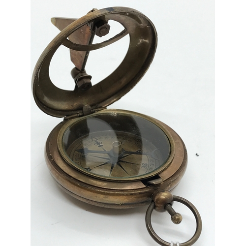 208 - A brass sundial and compass, stamped Ross London