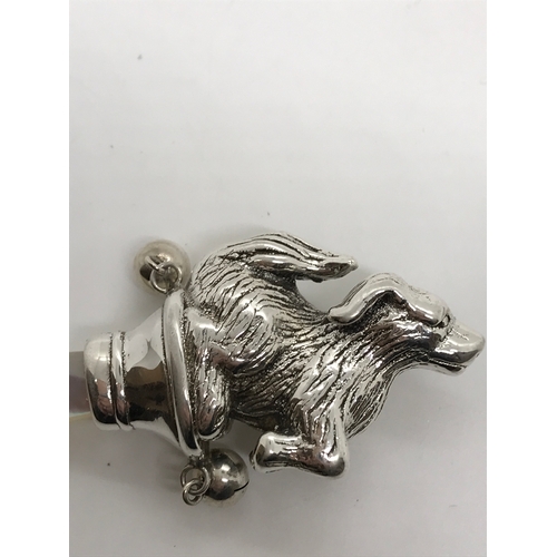 214 - A silver babies rattle in the form of a dog with mother of pearl teether/handle stamped Sterling