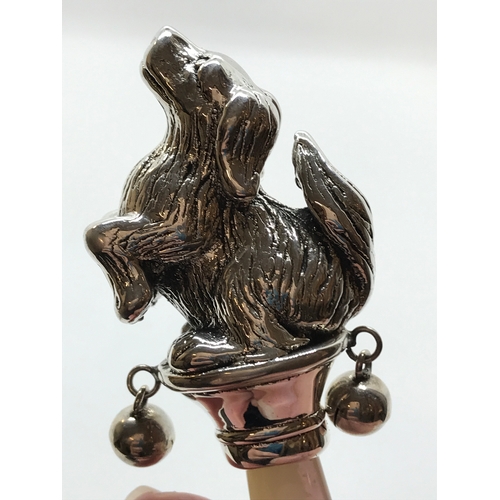 214 - A silver babies rattle in the form of a dog with mother of pearl teether/handle stamped Sterling