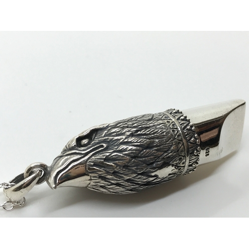 215 - A silver whistle in the form of a bird of prey on chain, stamped 925