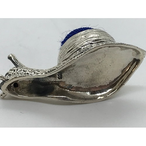 218 - A silver pin cushion in the form of a snail stamped 925