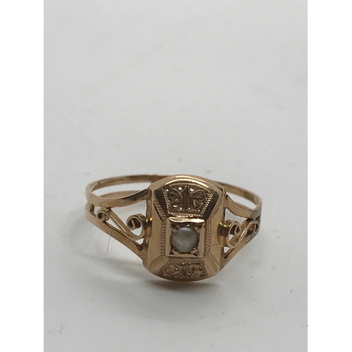 225 - Antique gold ring with scroll detailing to mount, central focal seed pearl, unmarked testing 18ct go... 