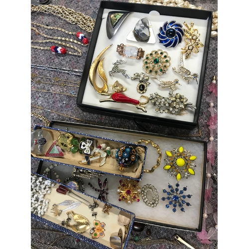 200A - A quantity of costume jewellery including necklaces, brooches, bracelets, earrings etc.