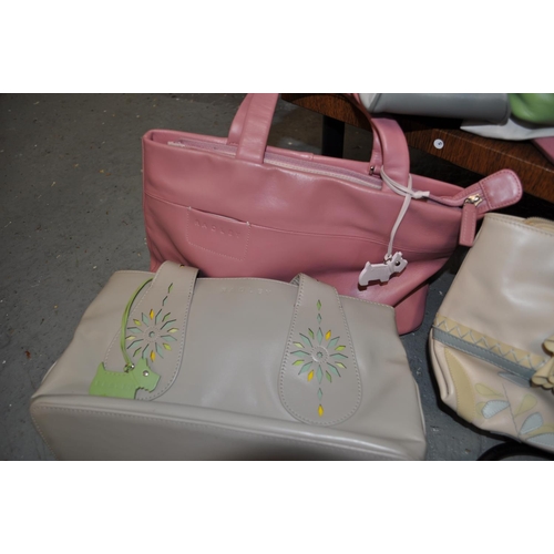 101 - A quantity of Radley handbags with dust bags